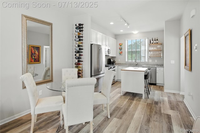 3317 Parkways Blvd, Auburn Hills, MI 48326 - dining area with light wood finished floors and rail lighting