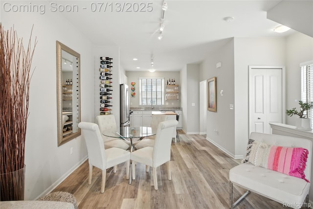 3317 Parkways Blvd, Auburn Hills, MI 48326 - dining room featuring light wood-style flooring and rail lighting