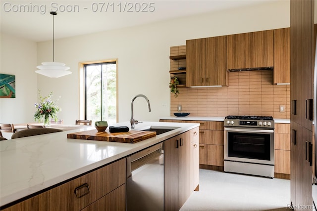 1539 Sycamore St, Detroit, MI 48208 - kitchen with appliances with stainless steel finishes, backsplash, hanging light fixtures, modern cabinets, and brown cabinets