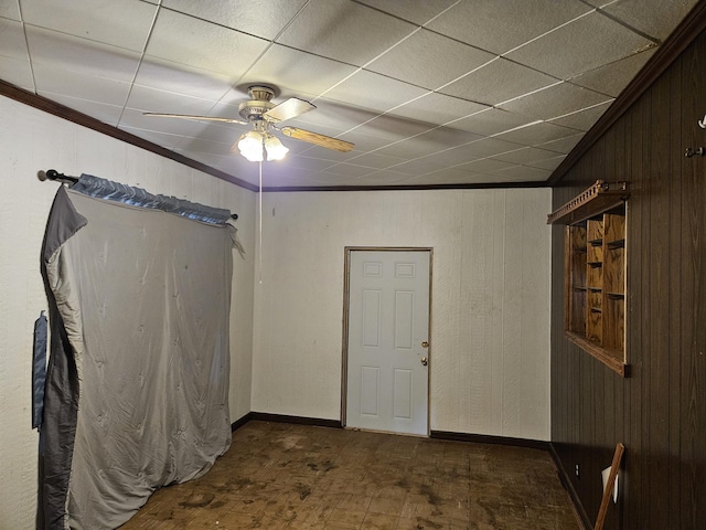 2768 W Winston Rd, Rothbury, MI 49452 - spare room with a ceiling fan, wooden walls, and crown molding