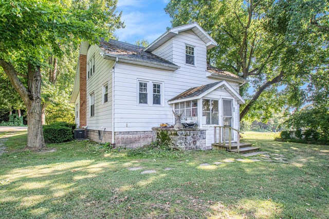 4471 Highland Ave, Benton Harbor, MI 49022 - rear view of property featuring a sunroom and a yard