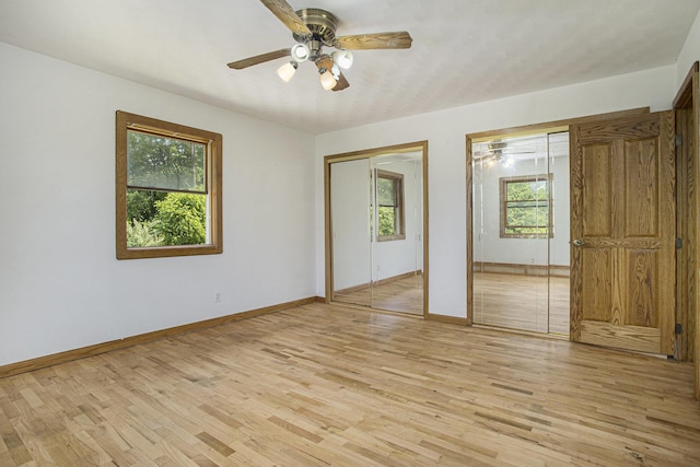 14083 M37, Battle Creek, MI 49017 - unfurnished bedroom featuring two closets, light wood finished floors, and ceiling fan