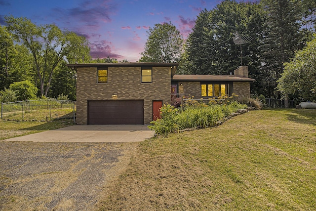 14083 M37, Battle Creek, MI 49017 - tri-level home featuring driveway, an attached garage, brick siding, and a chimney