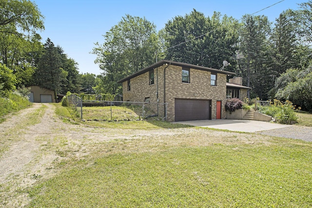 14083 M37, Battle Creek, MI 49017 - view of side of home featuring brick siding, driveway, and an attached garage