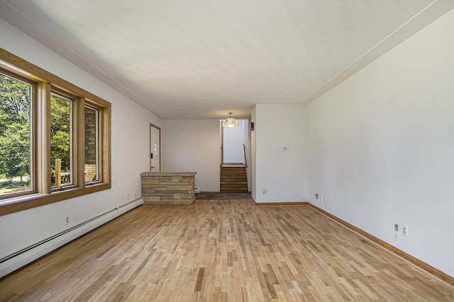 14083 M37, Battle Creek, MI 49017 - empty room with a baseboard radiator, light wood finished floors, and stairs