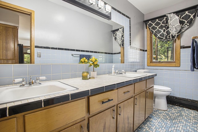 14083 M37, Battle Creek, MI 49017 - full bathroom with double vanity, tile walls, tile patterned flooring, and wainscoting