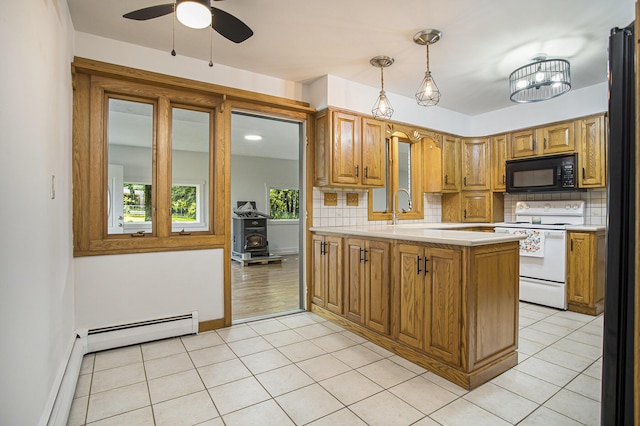 14083 M37, Battle Creek, MI 49017 - kitchen with white electric range oven, black microwave, a baseboard radiator, light countertops, and a peninsula