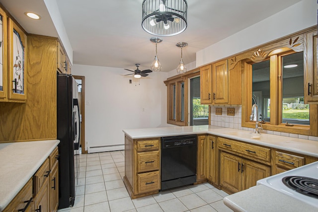 14083 M37, Battle Creek, MI 49017 - kitchen featuring black appliances, a baseboard radiator, brown cabinets, a peninsula, and light countertops