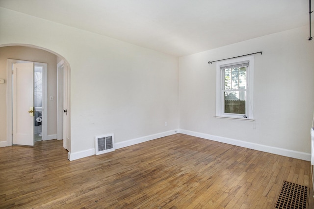 924 Royce Ave, Kalamazoo, MI 49001 - empty room featuring hardwood / wood-style floors and arched walkways