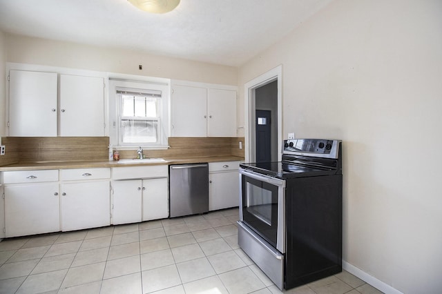 924 Royce Ave, Kalamazoo, MI 49001 - kitchen featuring stainless steel appliances, white cabinets, light tile patterned floors, and light countertops