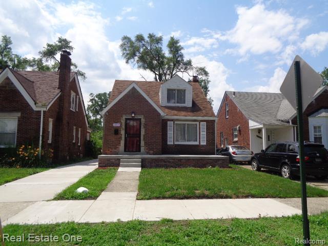 18259 Pinehurst St, Detroit, MI 48221 - view of front facade with brick siding, a front lawn, and a chimney