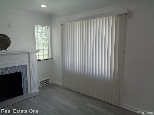 18259 Pinehurst St, Detroit, MI 48221 - unfurnished living room featuring wood finished floors, a fireplace, and recessed lighting