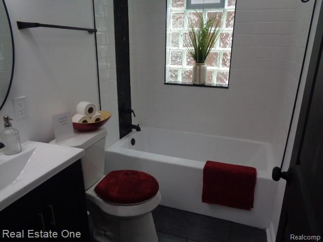 18259 Pinehurst St, Detroit, MI 48221 - bathroom with vanity, shower / tub combination, and tile patterned floors