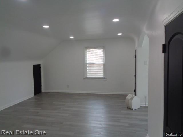 18259 Pinehurst St, Detroit, MI 48221 - additional living space with arched walkways, recessed lighting, wood finished floors, and lofted ceiling