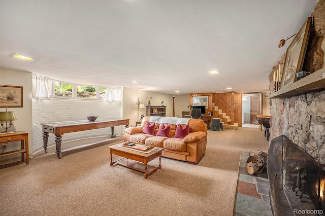 6400 N Rochester Rd, Rochester Hills, MI 48306 - living area featuring carpet flooring, stairway, and a stone fireplace
