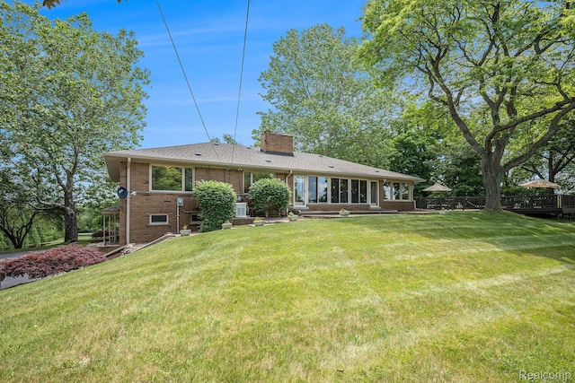 6400 N Rochester Rd, Rochester Hills, MI 48306 - back of property featuring a chimney, brick siding, and a lawn