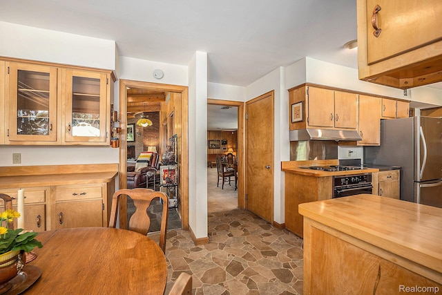 6400 N Rochester Rd, Rochester Hills, MI 48306 - kitchen with oven, under cabinet range hood, freestanding refrigerator, wooden counters, and stovetop