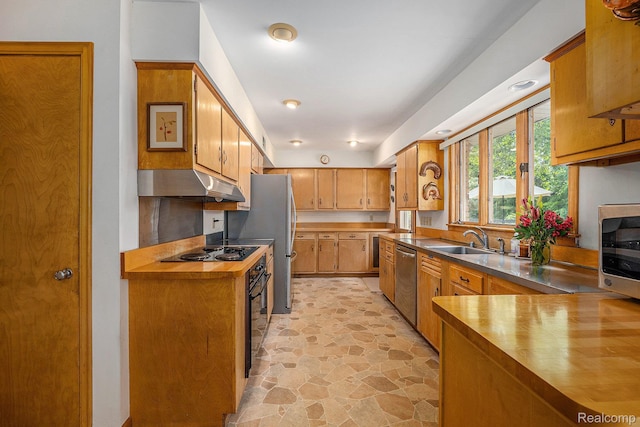 6400 N Rochester Rd, Rochester Hills, MI 48306 - kitchen featuring under cabinet range hood, black appliances, light stone finish flooring, butcher block counters, and brown cabinets