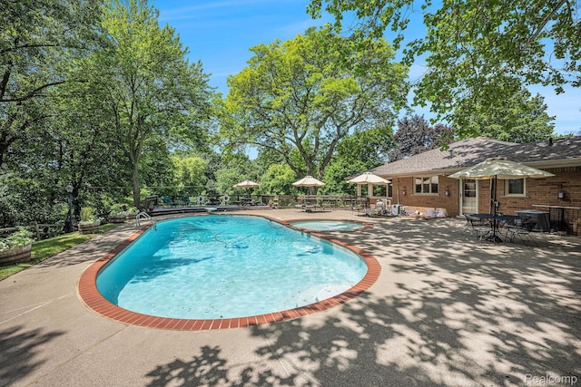 6400 N Rochester Rd, Rochester Hills, MI 48306 - view of pool featuring a patio area, a pool with connected hot tub, and view of scattered trees