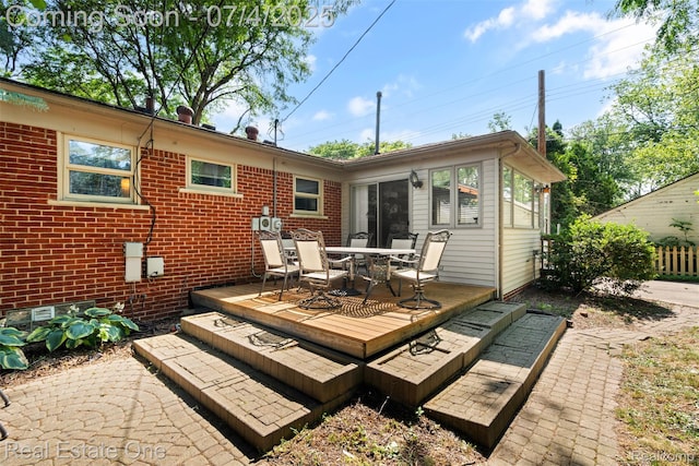17022 Marguerite St, Beverly Hills, MI 48025 - back of property featuring a deck, outdoor dining area, and brick siding