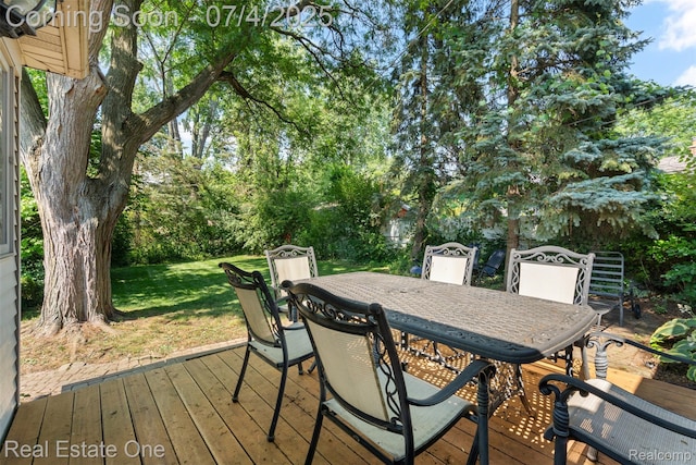 17022 Marguerite St, Beverly Hills, MI 48025 - wooden deck with outdoor dining space, a yard, and view of wooded area