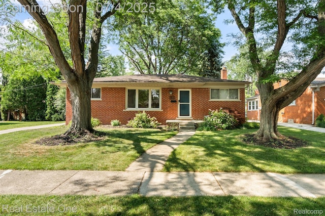 17022 Marguerite St, Beverly Hills, MI 48025 - ranch-style house with brick siding, a chimney, and a front yard
