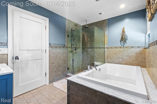 17022 Marguerite St, Beverly Hills, MI 48025 - full bathroom with tile walls, a stall shower, tile patterned floors, a garden tub, and vanity