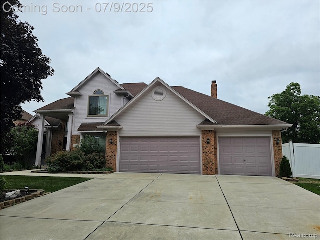 6942 Norton Dr, Troy, MI 48085 - view of front of house featuring a garage, brick siding, driveway, a chimney, and roof with shingles
