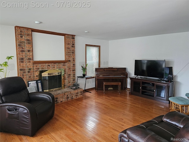6942 Norton Dr, Troy, MI 48085 - living area with a brick fireplace and wood finished floors