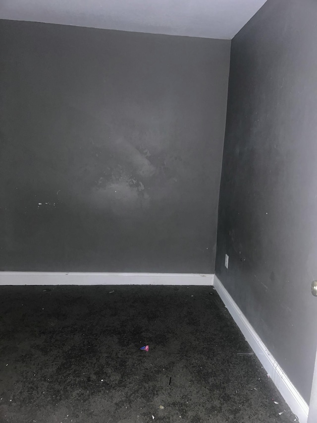 1615 Dyson St, Muskegon, MI 49442 - empty room featuring unfinished concrete floors and baseboards