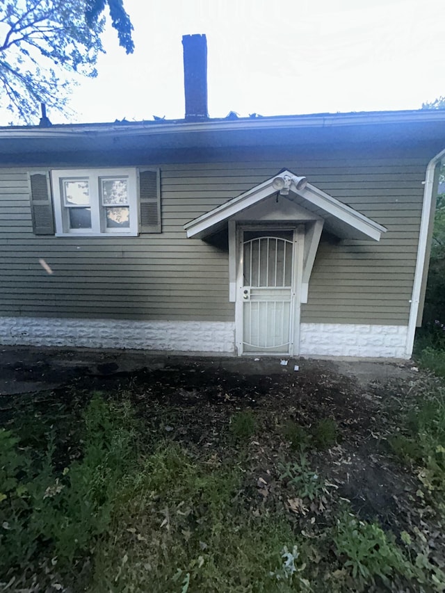 1615 Dyson St, Muskegon, MI 49442 - doorway to property featuring a chimney