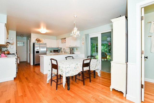 50983 Kiawah Trl, Mattawan, MI 49071 - dining space with light wood-style floors and a chandelier
