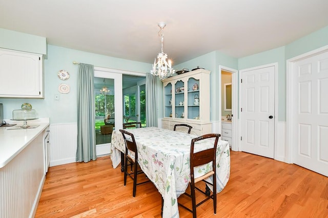 50983 Kiawah Trl, Mattawan, MI 49071 - dining room featuring a chandelier, light wood-style floors, and a wainscoted wall