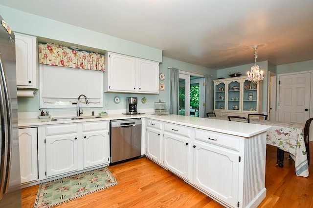 50983 Kiawah Trl, Mattawan, MI 49071 - kitchen featuring stainless steel appliances, a peninsula, a chandelier, and white cabinets