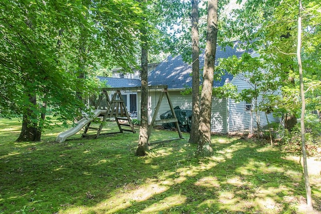 50983 Kiawah Trl, Mattawan, MI 49071 - back of house featuring a shingled roof, a playground, and a lawn