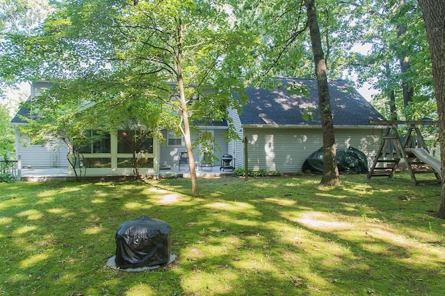 50983 Kiawah Trl, Mattawan, MI 49071 - rear view of house with a yard, roof with shingles, and a playground
