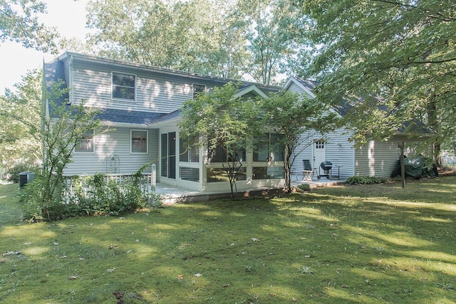 50983 Kiawah Trl, Mattawan, MI 49071 - rear view of property with a sunroom, a patio area, and a lawn