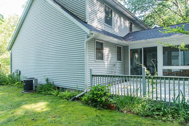 50983 Kiawah Trl, Mattawan, MI 49071 - view of property exterior with a sunroom, a shingled roof, a lawn, and a wooden deck