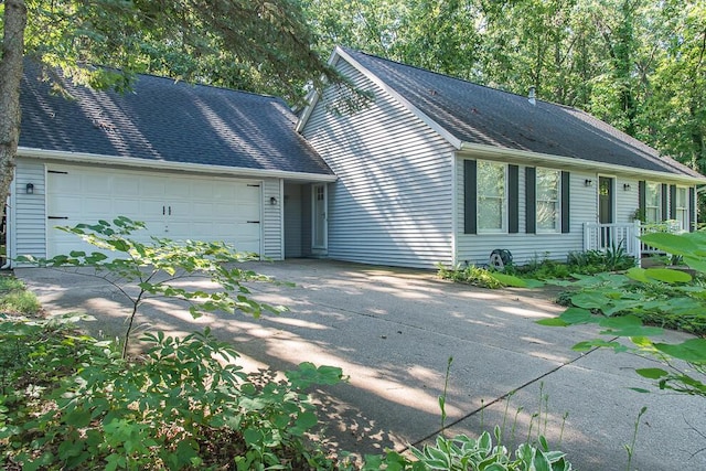 50983 Kiawah Trl, Mattawan, MI 49071 - view of front of house featuring concrete driveway, a garage, and roof with shingles