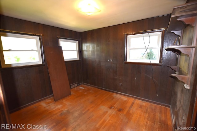 22150 Beverly St, Oak Park, MI 48237 - unfurnished room featuring light wood finished floors and wood walls