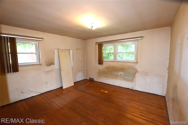 22150 Beverly St, Oak Park, MI 48237 - unfurnished bedroom with multiple windows and wood finished floors