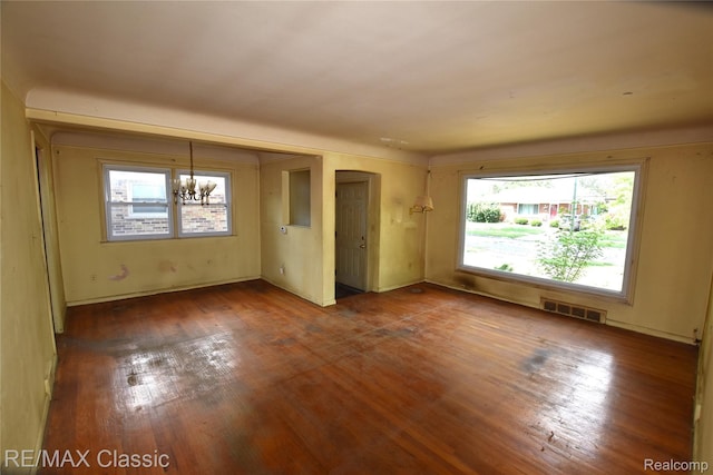 22150 Beverly St, Oak Park, MI 48237 - empty room featuring healthy amount of natural light, wood finished floors, and a chandelier