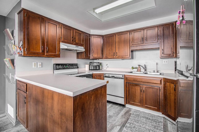 3265 Elmwood Beach Rd, Middleville, MI 49333 - kitchen with white dishwasher, electric range, under cabinet range hood, fridge, and light countertops