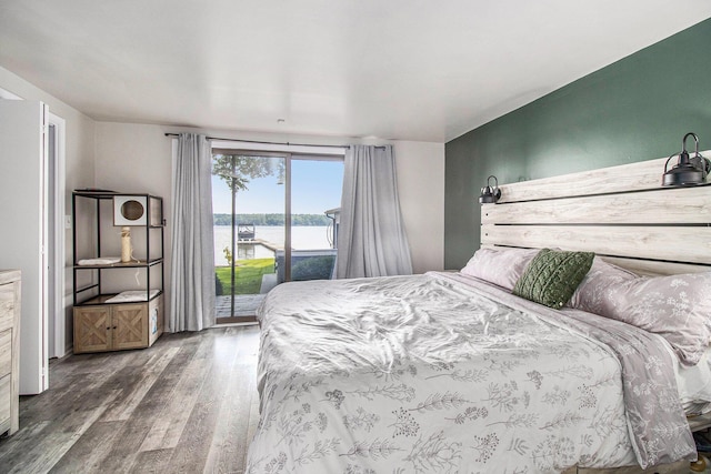 3265 Elmwood Beach Rd, Middleville, MI 49333 - bedroom featuring access to exterior, wood finished floors, and a water view