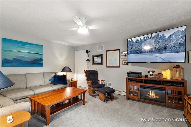 46 Counts Cove Ct, Holland, MI 49424 - living area featuring a ceiling fan, carpet floors, a baseboard radiator, a baseboard heating unit, and a glass covered fireplace