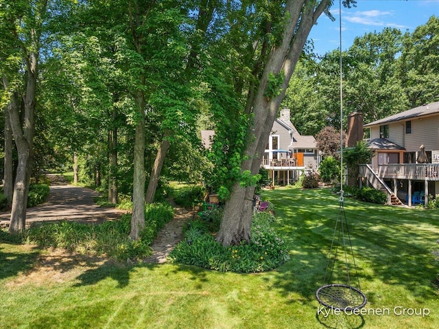 46 Counts Cove Ct, Holland, MI 49424 - view of grassy yard featuring stairway and a wooden deck