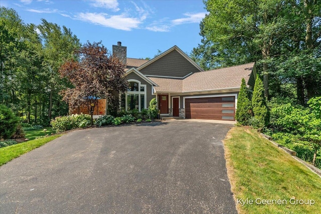46 Counts Cove Ct, Holland, MI 49424 - view of front of house with an attached garage, driveway, and a chimney