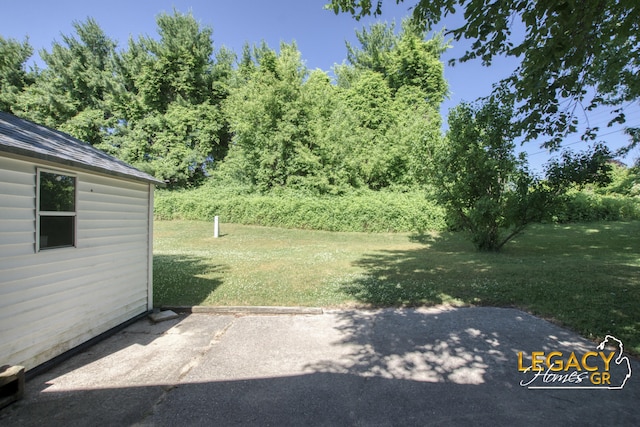 1163 Maple Leaf Ln NW, Walker, MI 49534 - view of green lawn featuring a patio