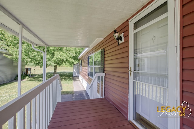 1163 Maple Leaf Ln NW, Walker, MI 49534 - wooden porch featuring a yard