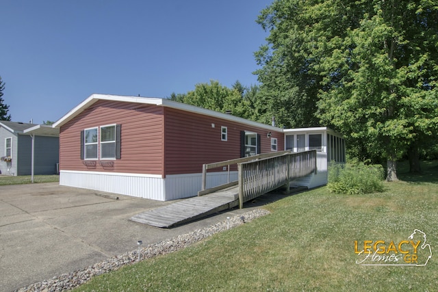 1163 Maple Leaf Ln NW, Walker, MI 49534 - view of side of home featuring a wooden deck and a yard
